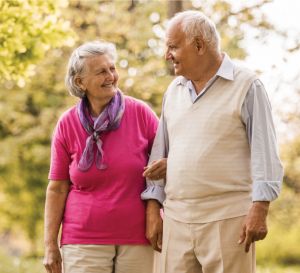 senior couple walking on a path outside