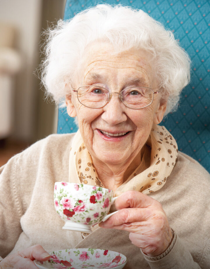 Happy-Senior-Woman-Enjoying-a-Cup-of-Tea Happy Senior Woman drinking a cup of tea