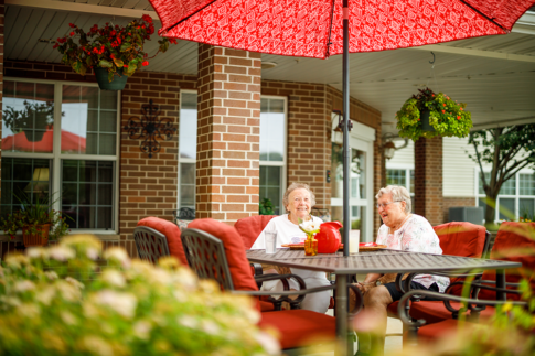 Female residents enjoying each other's company on our outdoor patio