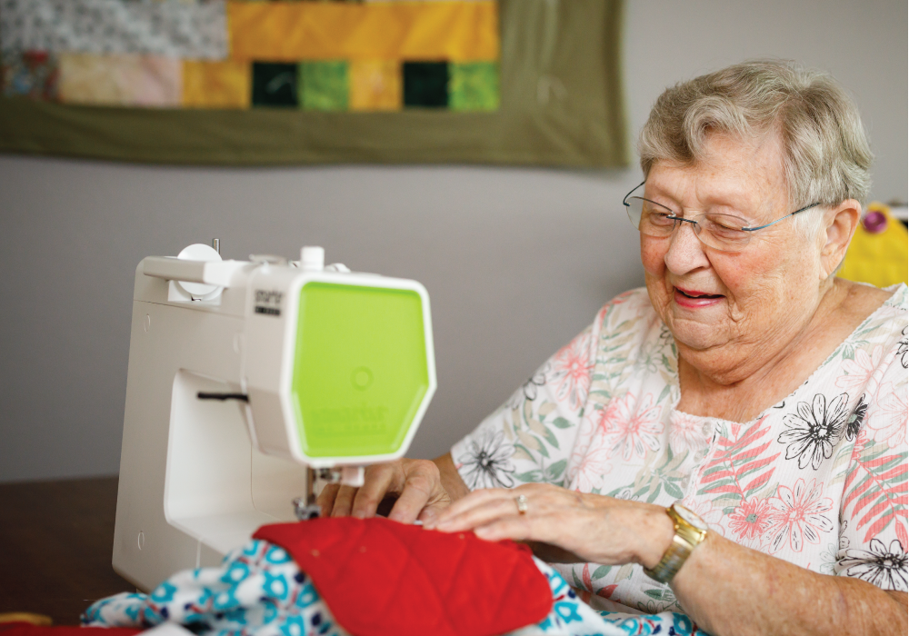 Senior resident sewing