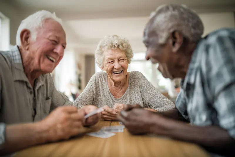Parkside Cares | Seniors playing cards laughing